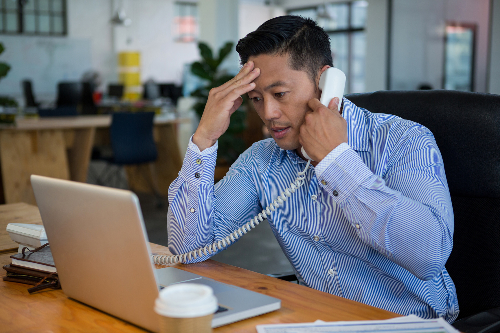 Frustrated business executive talking on telephone